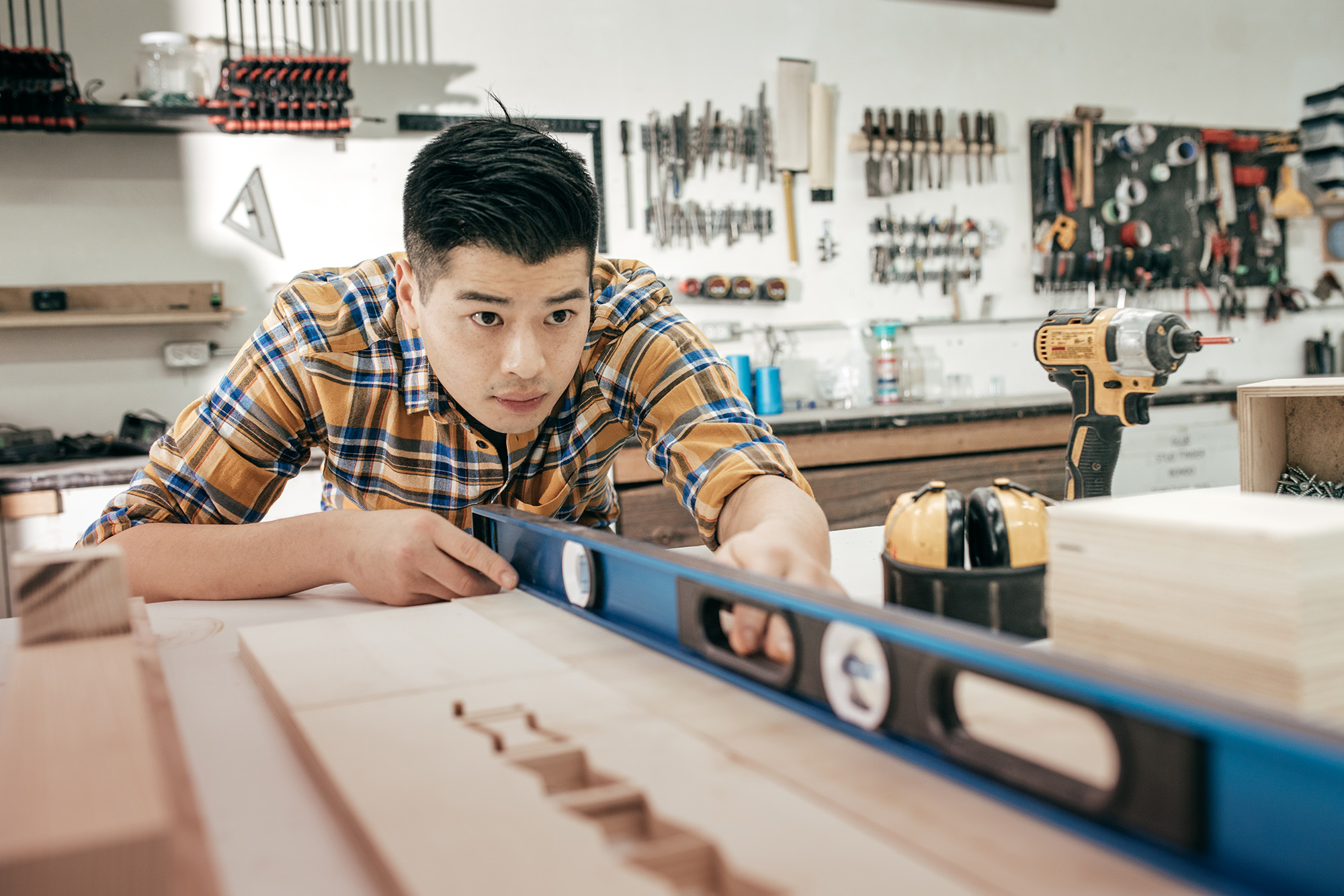 Professional young asian man working as a carpenter